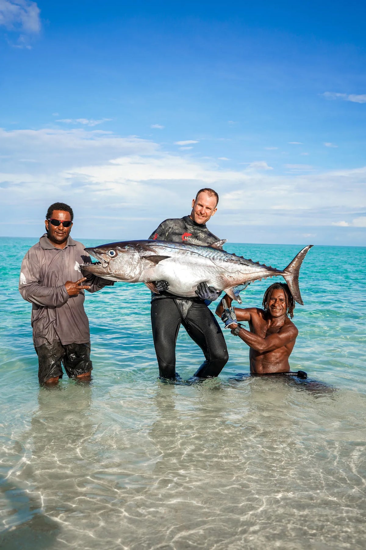 Dogtooth tuna held in shallow water after a Reef Lagoon Charters spearfishing expedition in Papua New Guinea